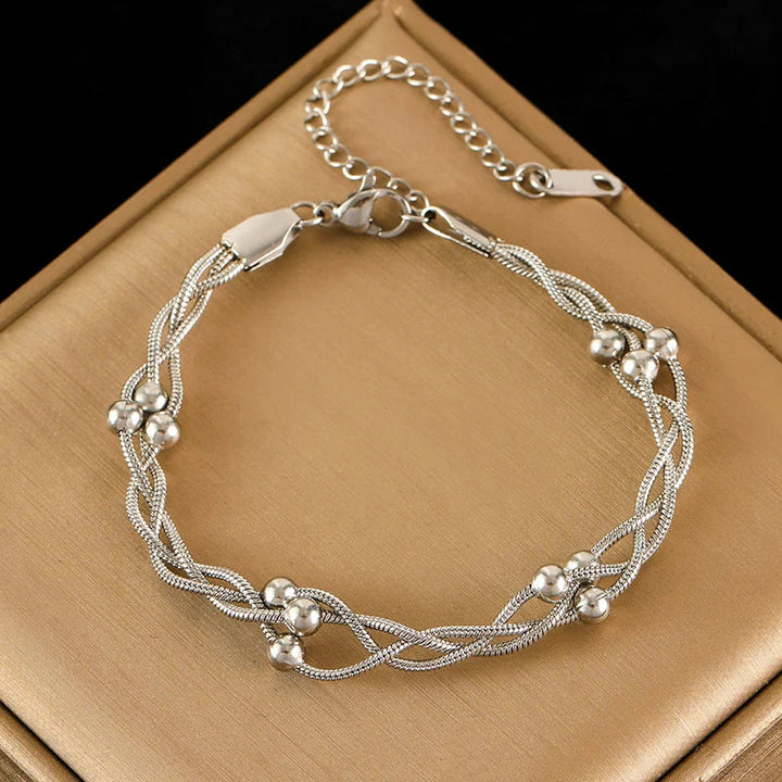 Stylish women's layered snake chain bracelet in silver, adjustable. Elegant stainless steel jewelry for women.