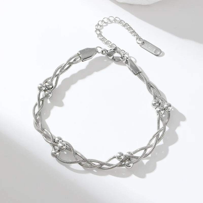 Women's chic layered snake chain bracelet, gold or silver stainless steel. Elegant, adjustable, and versatile jewelry.
