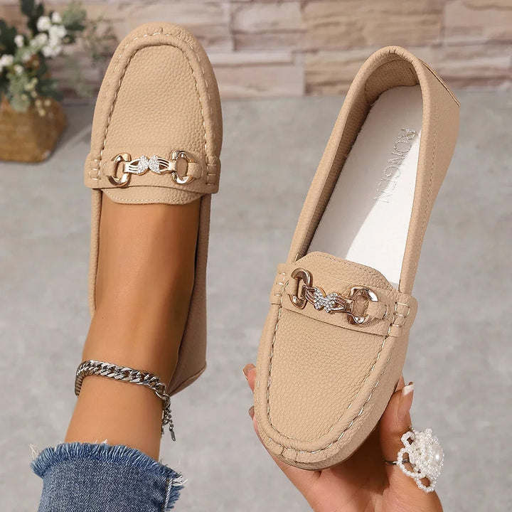 Side view of comfortable women's slip-on loafers with a subtle, yet elegant, crystal chain accent.