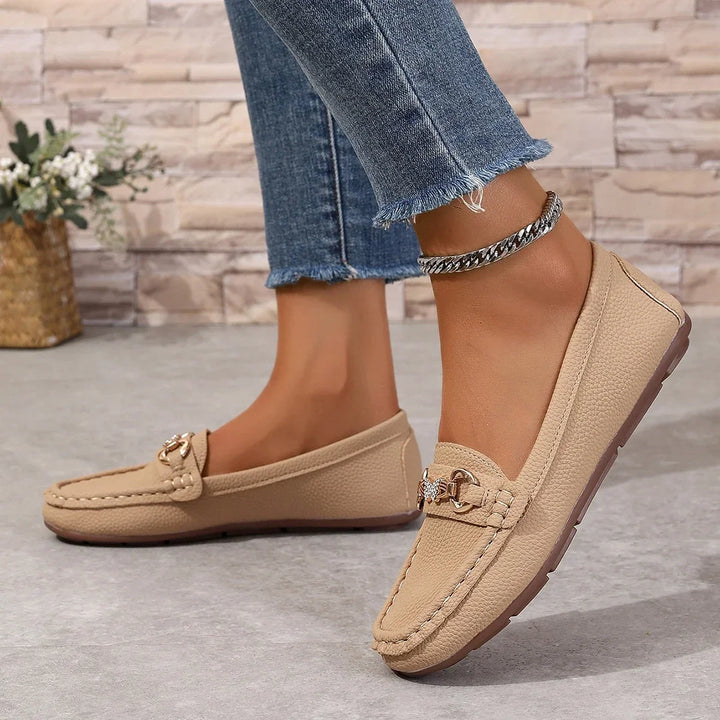 Sophisticated women's loafers with a smooth finish and a dazzling crystal chain on the upper.