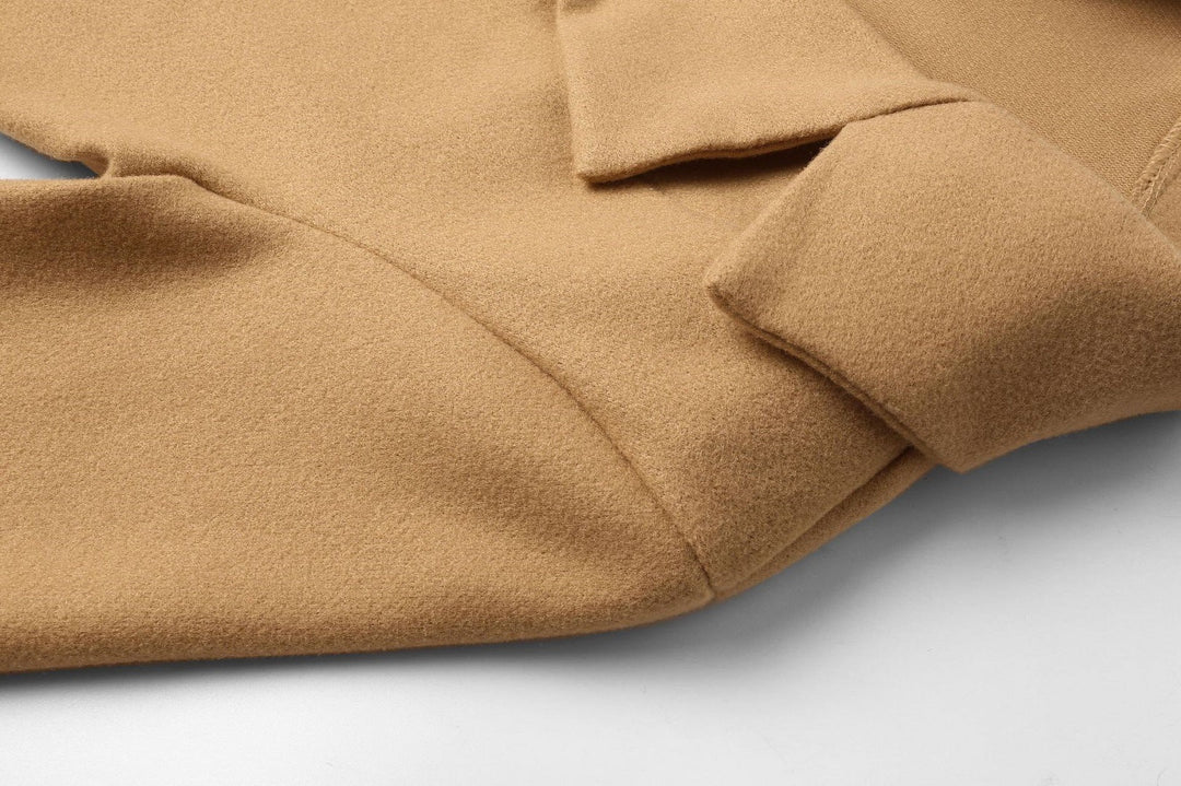 Elegant long double-breasted coat for women. Stylish wool-look design, perfect for sophisticated winter attire.