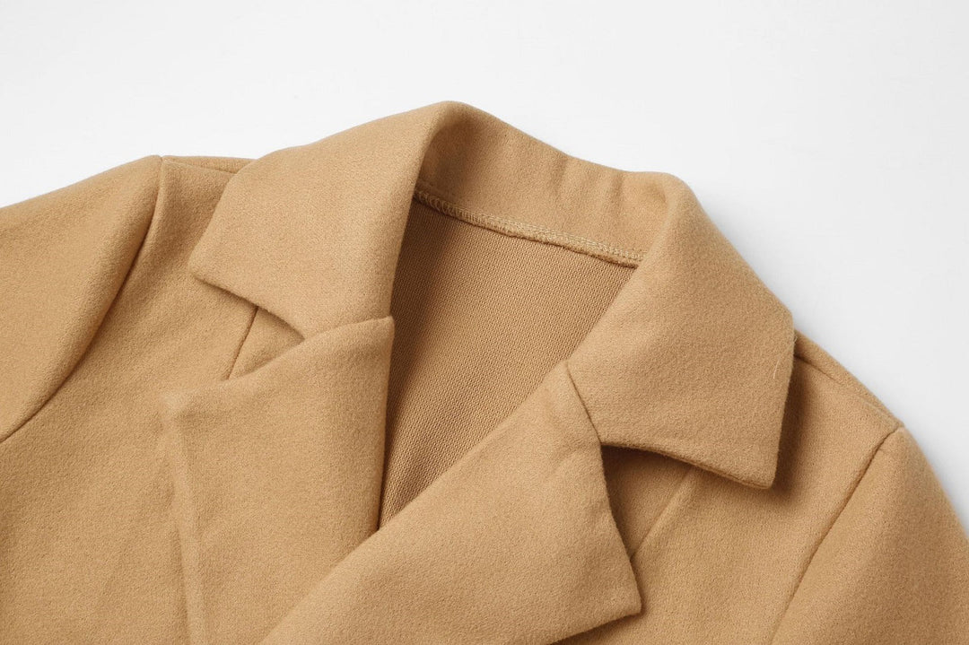 Warm long double-breasted winter coat for women. Classic wool-look design, ideal for seasonal elegance.