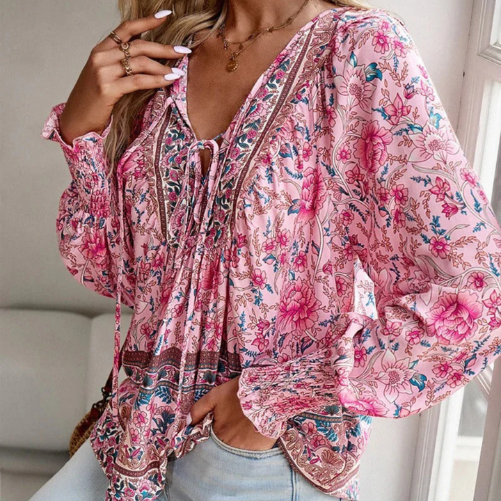 Stylish women's blouse featuring a beautiful floral print, an elegant choice for spring and summer outfits.