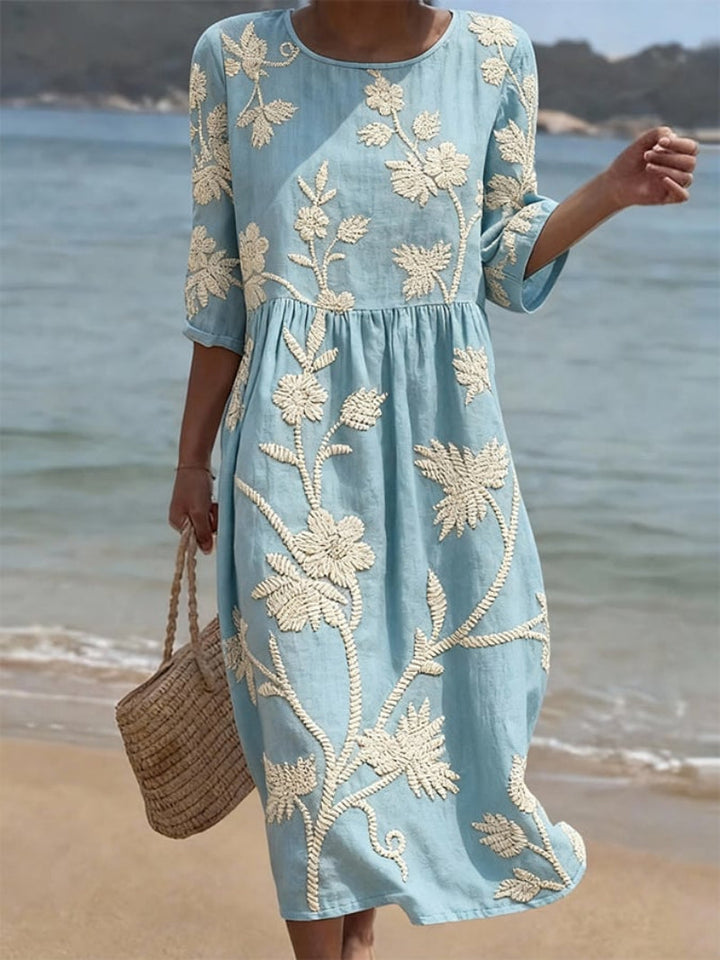 Women's elegant midi dress with intricate floral embroidery & three-quarter sleeves. Perfect for spring/summer fashion.