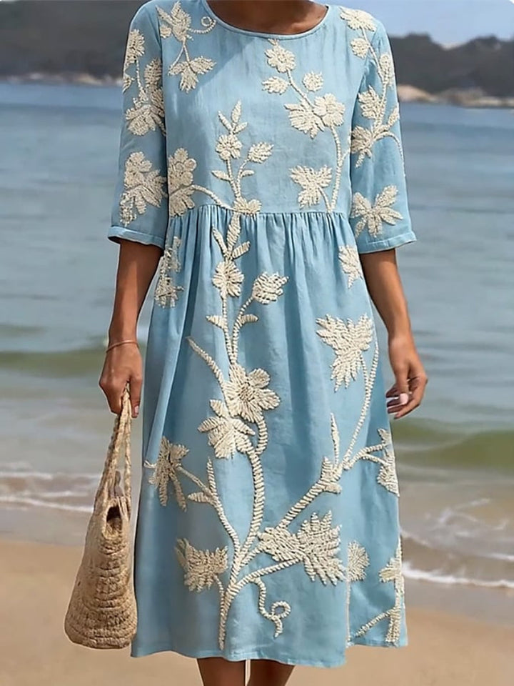 Relaxed fit women's midi dress, elegant with floral embroidery, round neck, & three-quarter sleeves for day wear.