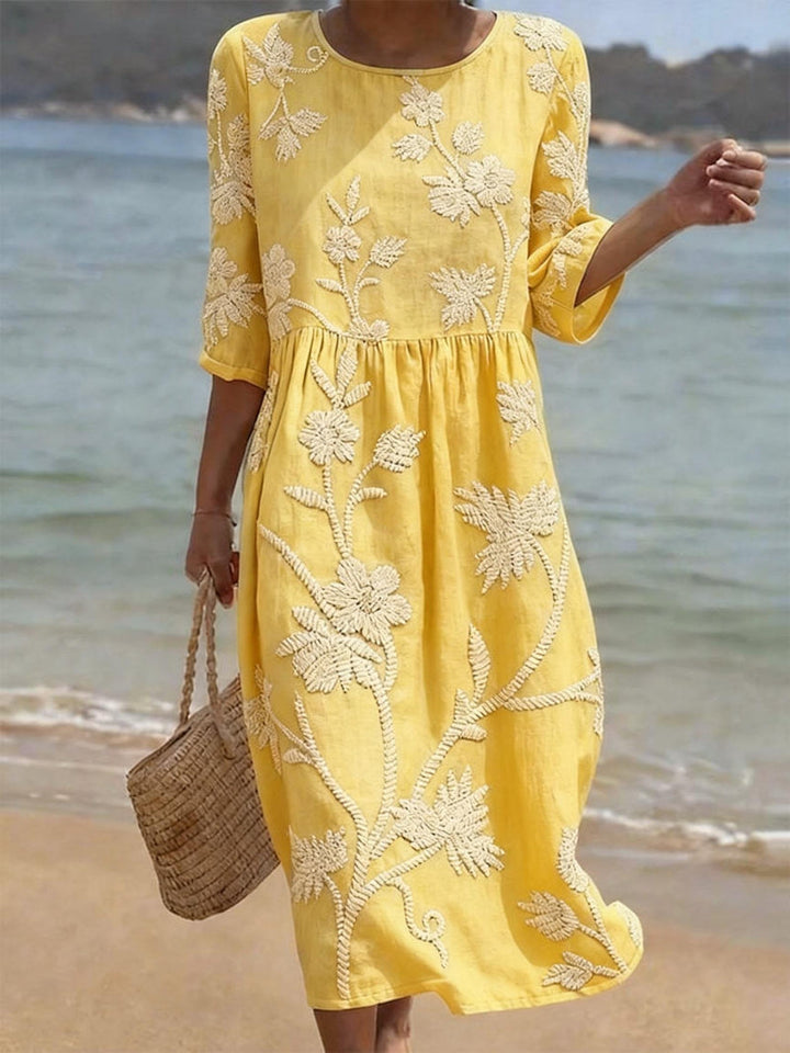 Beautiful women's embroidered midi dress with floral design & comfortable three-quarter sleeves for elegant style.
