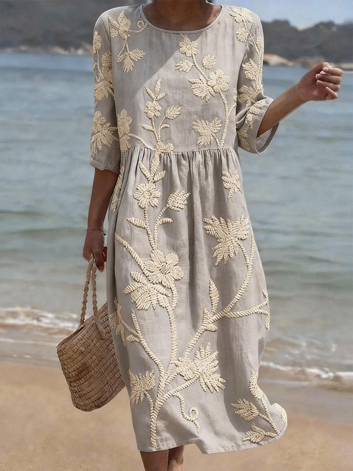 Chic women's casual midi dress with elegant floral embroidery, three-quarter sleeves, and a relaxed fit.