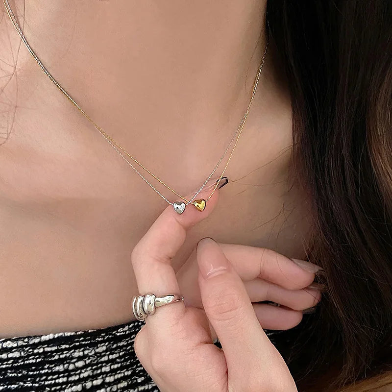 Women's elegant minimalist heart necklace, sleek stainless steel design. Perfect dainty gift for her.
