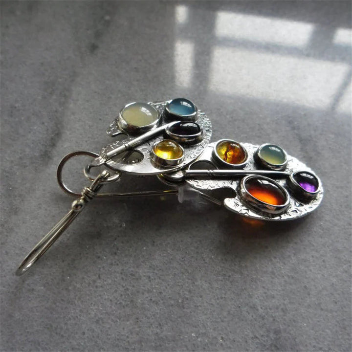 Colorful women's pendant earrings with shimmering multicolored stones. Elegant silver jewelry for a special gift.