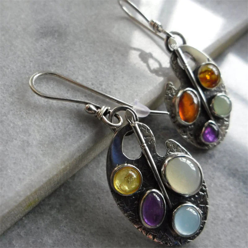 Vibrant multicolored stone pendant earrings for women. Elegant silver jewelry, sparkling and eye-catching statement piece.