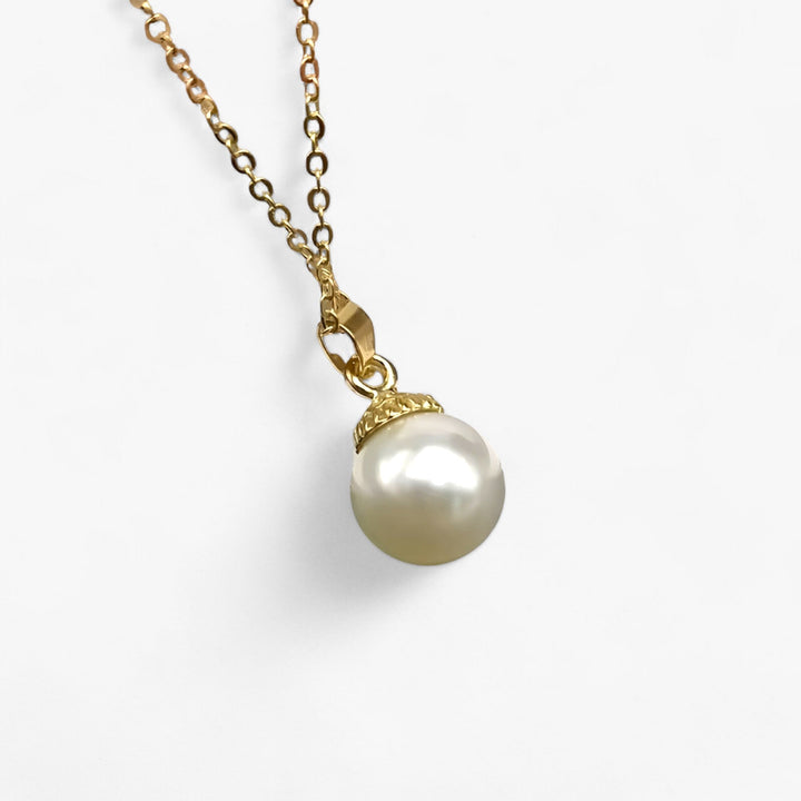 Trendy women's pearl & seashell pendant necklace. Features natural ocean charms for a chic summer jewelry look.