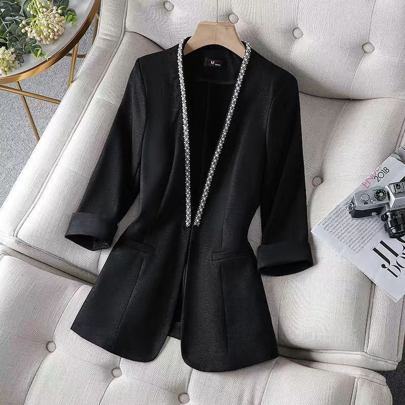 Chic women's blazer jacket featuring elegant pearl trim, open front design. Great for office workwear.