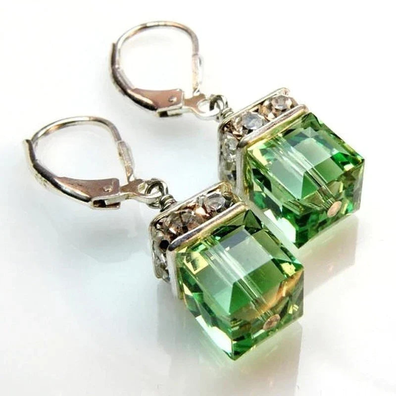 Women's elegant peridot crystal drop earrings. Beautiful green gemstone dangle earrings for a sophisticated look.