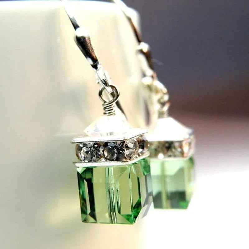 Stylish peridot crystal drop earrings with vibrant green gemstones. Perfect women's fashion dangle earrings for elegance.