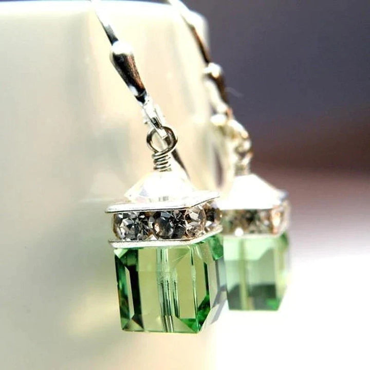 Stylish peridot crystal drop earrings with vibrant green gemstones. Perfect women's fashion dangle earrings for elegance.