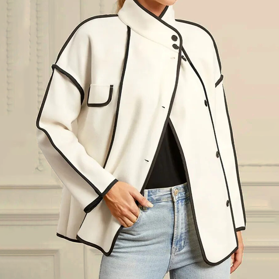 Close-up of women's elegant piped insulated jacket, showcasing premium piping detail & cozy warmth. Versatile fashion.