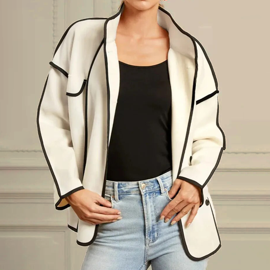 Fashionable women's elegant piped insulated jacket styled on a model. Premium quality and chic for a sophisticated look.