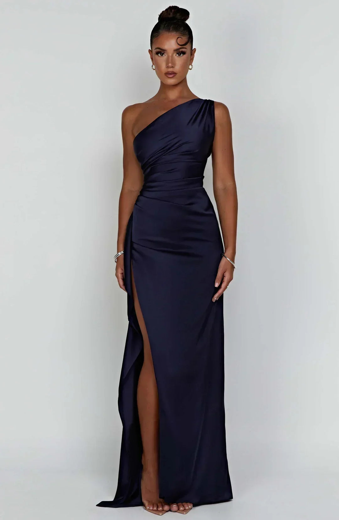 Sophisticated black formal dress with luxurious pleats and an elegant unique shoulder.