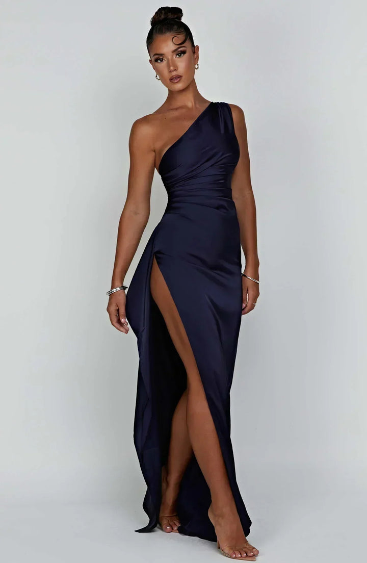 Red pleated formal gown, unique shoulder, and luxurious satin fabric for galas.