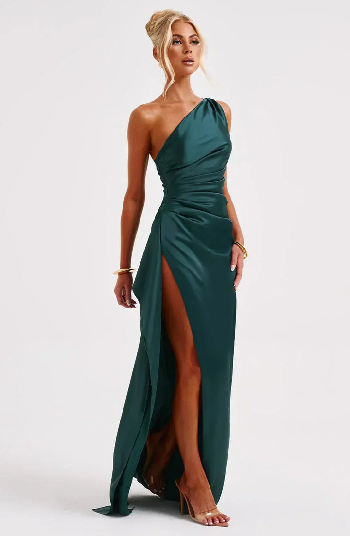 Elegant marine blue special occasion dress, unique shoulder, with graceful pleats.