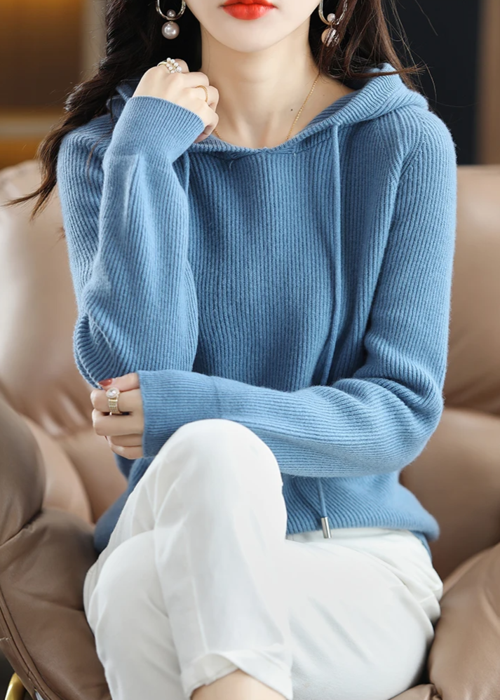 Elegant women's ribbed knit hoodie, soft pullover with drawstring, great for cozy wear.
