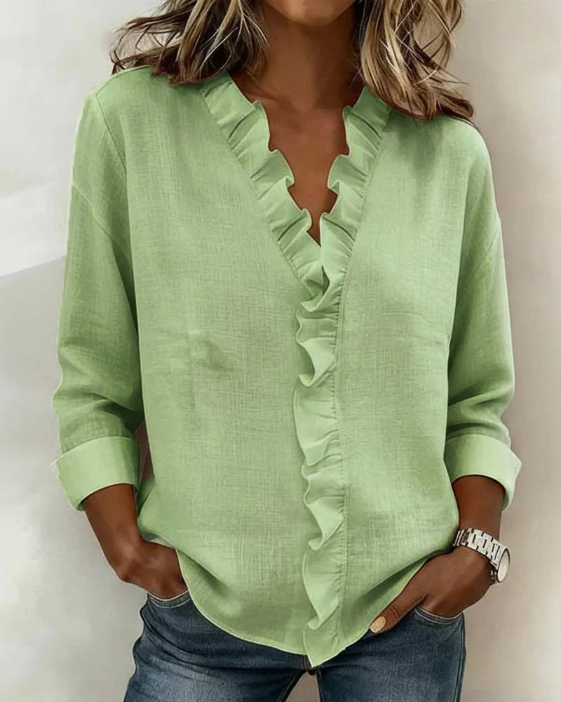 White women's long sleeve ruffled V-neck blouse, a versatile and elegant clothing item.
