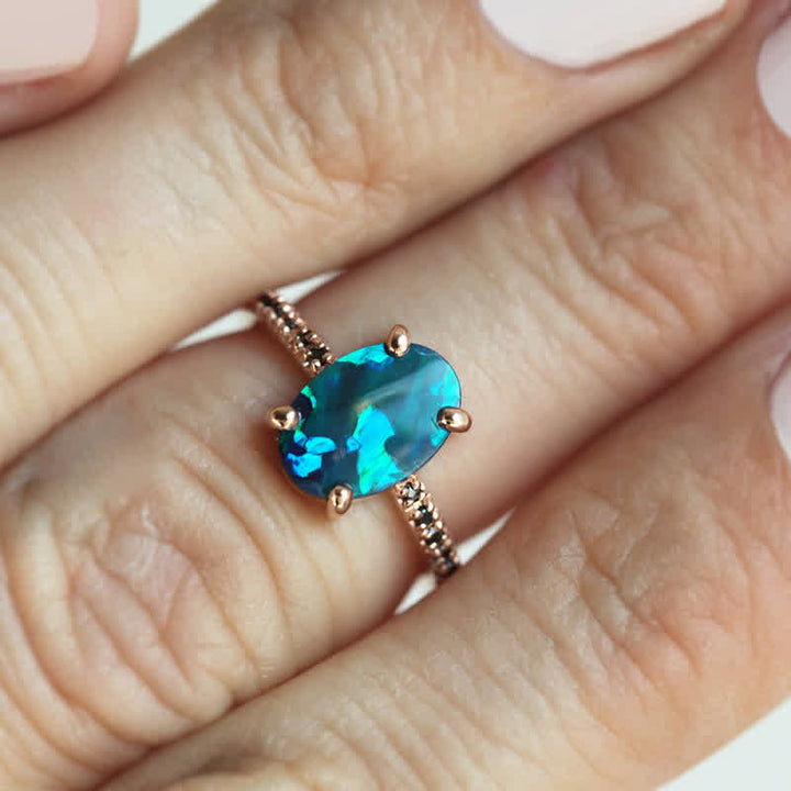 Angled view of women's elegant sapphire & opal 3-piece ring set. Fine jewelry, stackable gemstone rings.