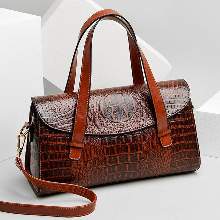 Chic women's crocodile embossed shoulder bag, versatile as a handbag or crossbody. Available in brown, black, burgundy.