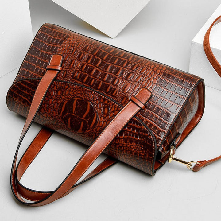 Designer inspired women's shoulder bag, featuring elegant crocodile embossing. A stylish fashion accessory for any outfit.
