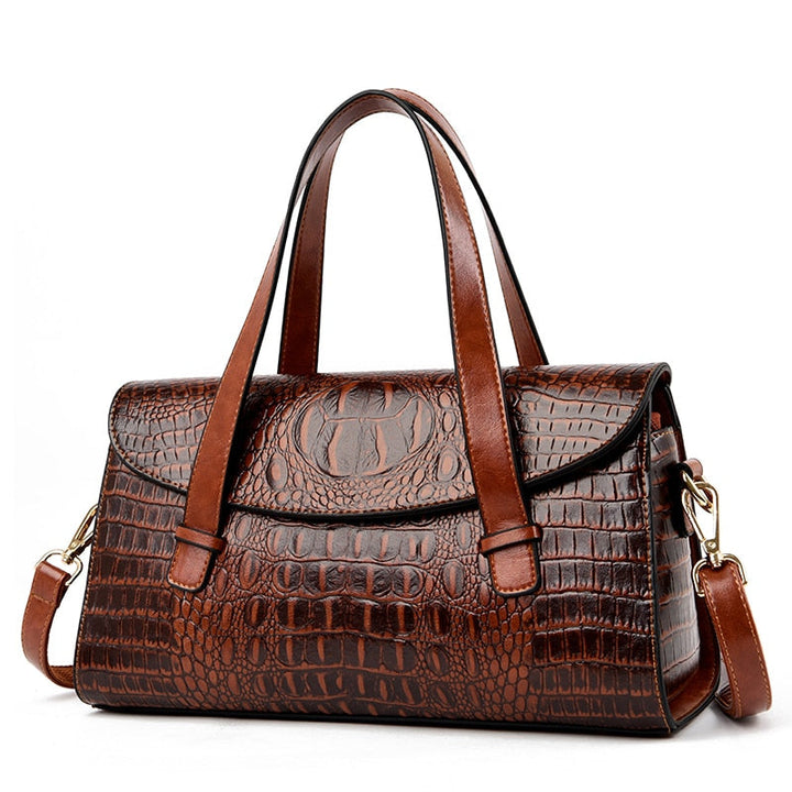 Close-up of elegant women's shoulder bag, showcasing intricate crocodile embossing. A chic fashion statement handbag.