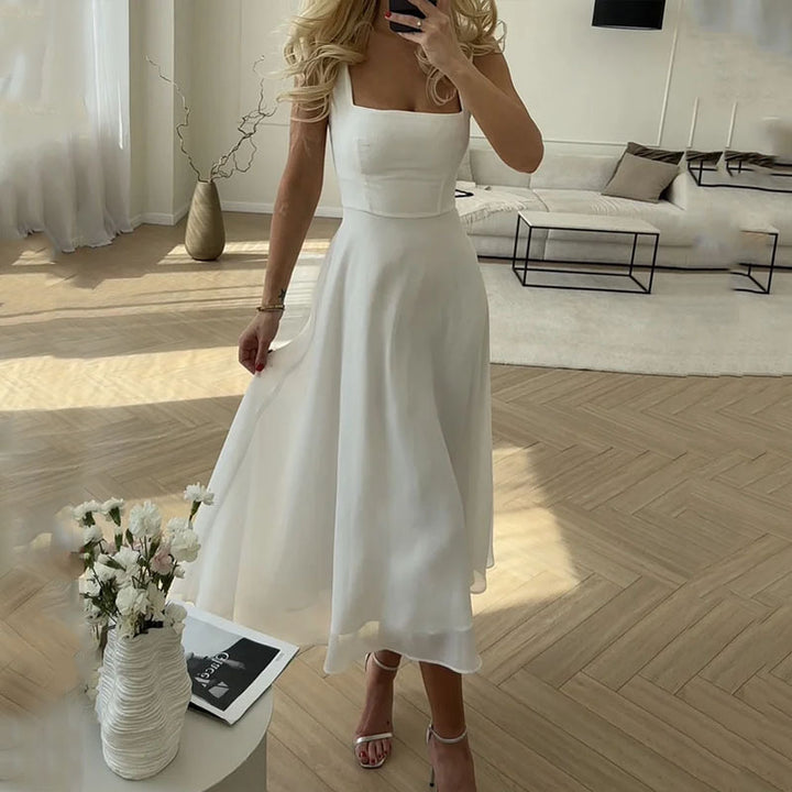 Women's elegant sleeveless midi dress in a solid color, perfect for formal or casual chic day-to-night wear.