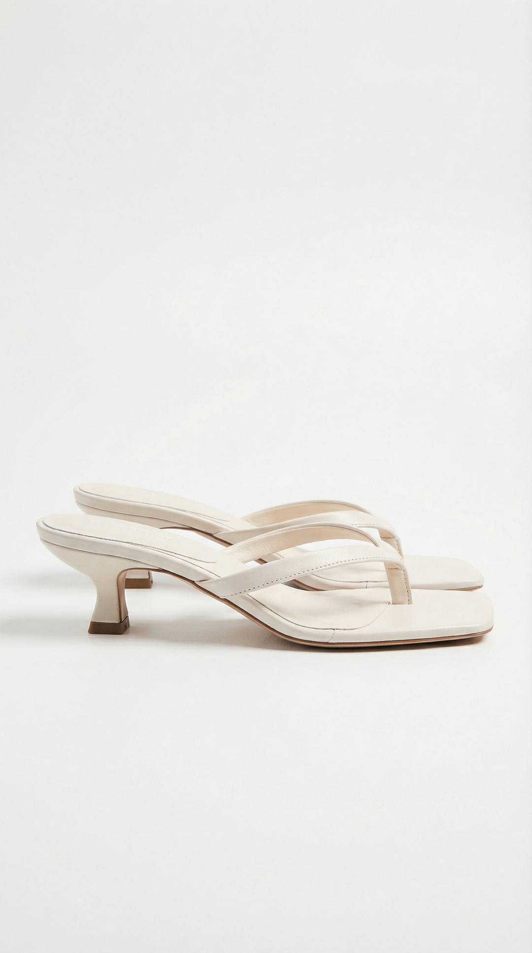 Elegant women's fashion footwear: square toe thong sandals with a flattering kitten heel.