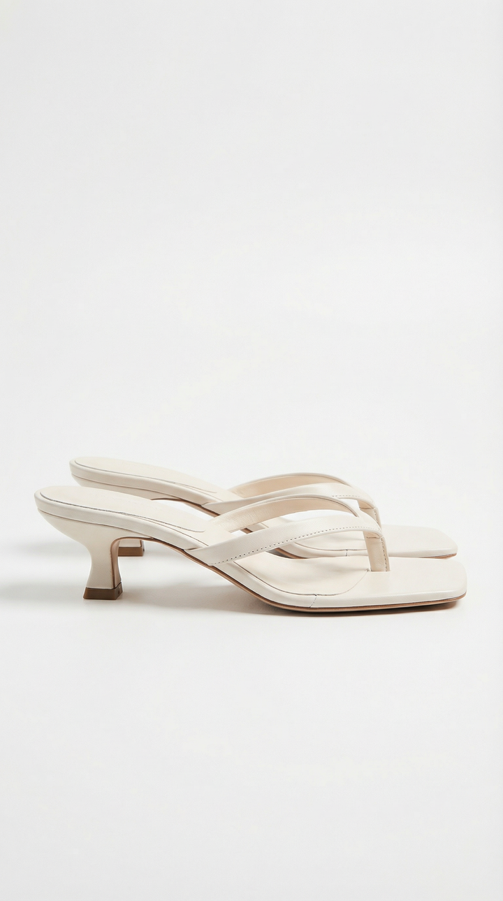 Elegant women's fashion footwear: square toe thong sandals with a flattering kitten heel.