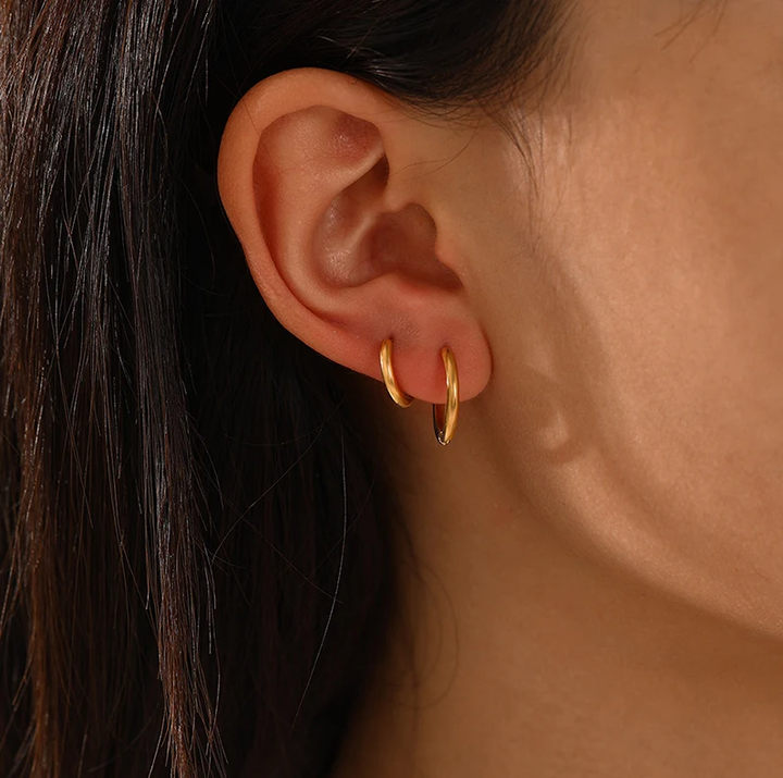 Stylish women's gold hoop earrings made of hypoallergenic material, a jewelry classic