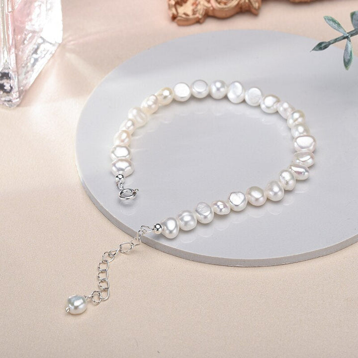 Adjustable sterling silver bracelet featuring lustrous freshwater pearls for women. Fine, elegant jewelry.