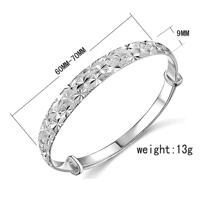 Glimmering women's sterling silver bracelet, star charm design, adjustable for everyday elegance.