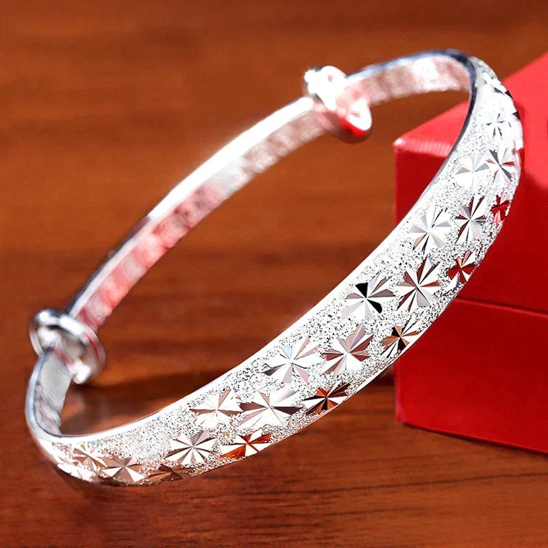 Adjustable sterling silver bracelet for women featuring a delicate star charm. Perfect gift.