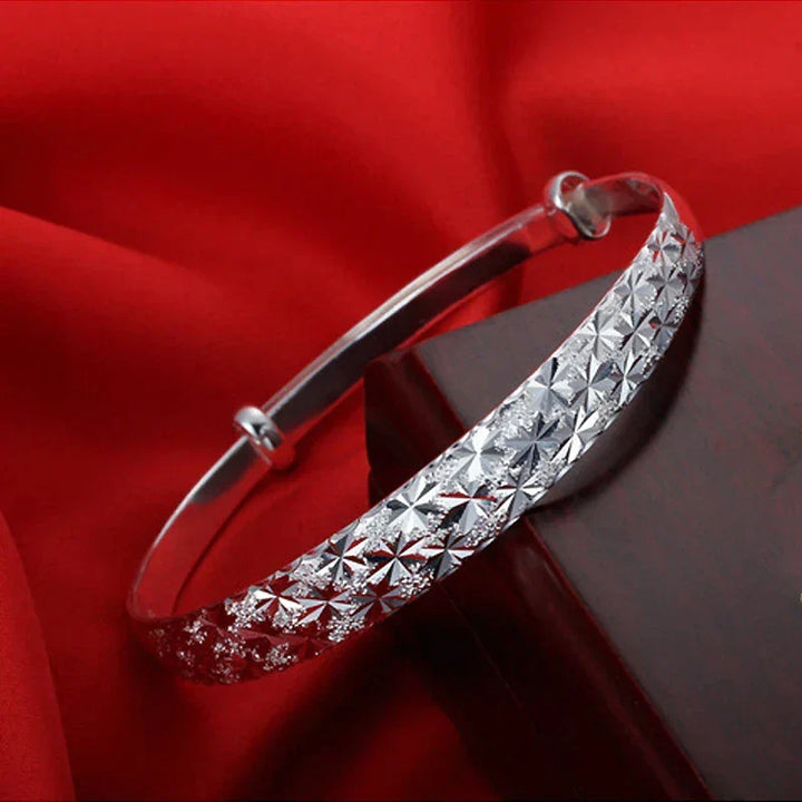 Delicate sterling silver star charm bracelet for women. Elegant, adjustable fit, everyday wear.