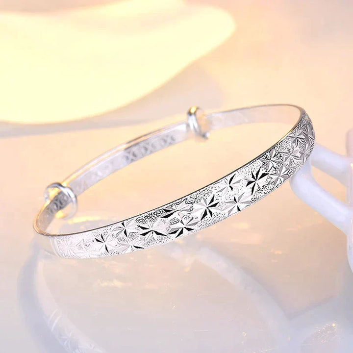 Dainty sterling silver star charm bracelet, adjustable for women, adds a touch of elegance.