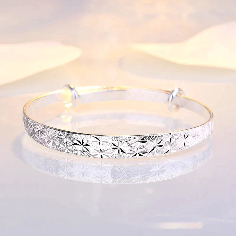 Shining star charm on an adjustable sterling silver women's bracelet. Elegant & versatile.