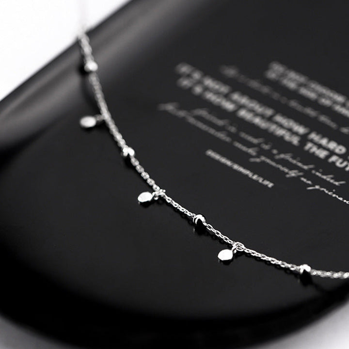 Close-up of the elegant silver teardrop pendant, sparkling women's fashion jewelry gift.