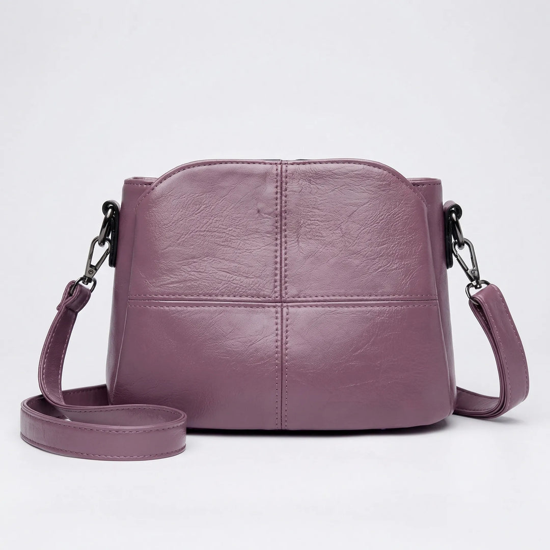 Women's elegant shoulder bag, a compact accessory with unique stitched panel design, versatile.