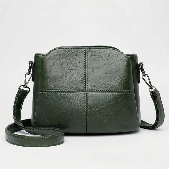 Chic women's crossbody & shoulder bag, featuring stitched panels; a versatile handbag in red, black, green, purple.