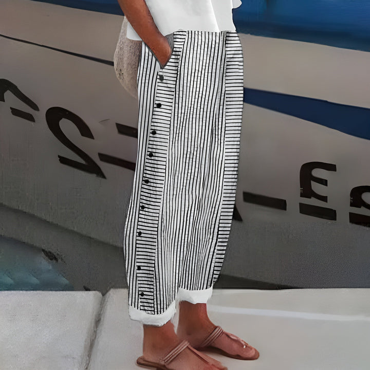 Mid-rise women's cropped trousers featuring a chic stripe panel and stylish button accents. Ideal for workwear.