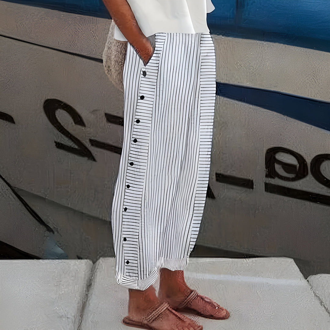 Fashionable women's straight leg cropped trousers with elegant stripe panel and button detail for casual chic summer.