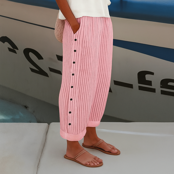 Women's casual chic cropped trousers with a distinctive stripe panel and decorative button details. Great for spring.