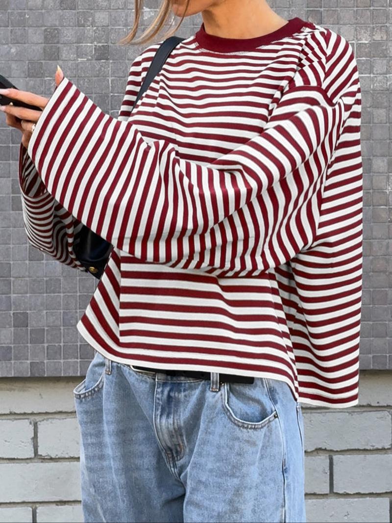 Stylish women's top featuring elegant striped pattern and prominent bell sleeves, offering a modern, relaxed fit.