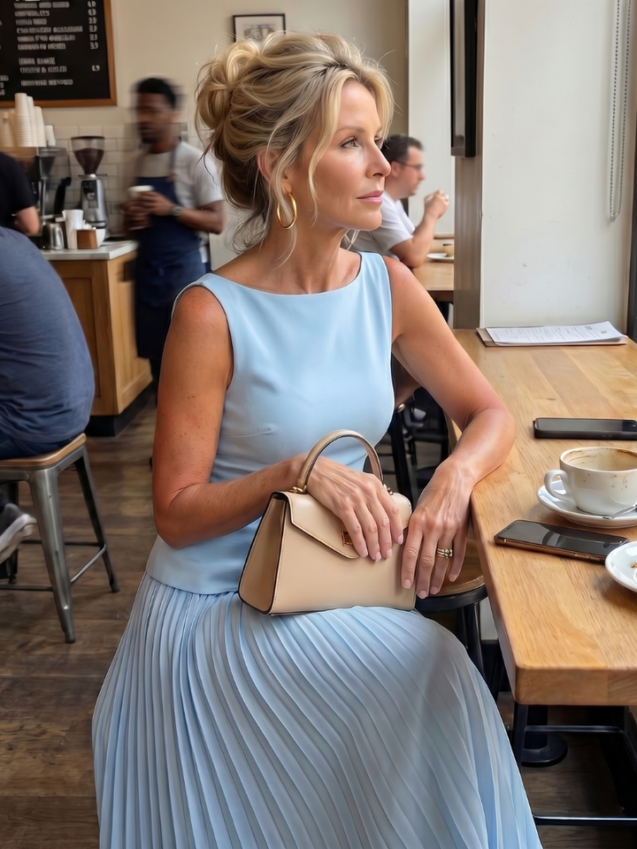 Fashion-forward women's skirt set featuring a structured bodice and a full, flowing pleated maxi skirt.