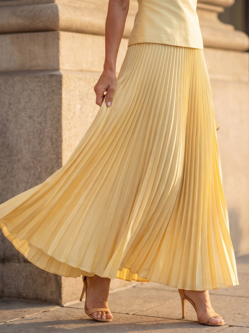 Stylish women's coordinated set featuring a structured top and a graceful pleated maxi skirt.