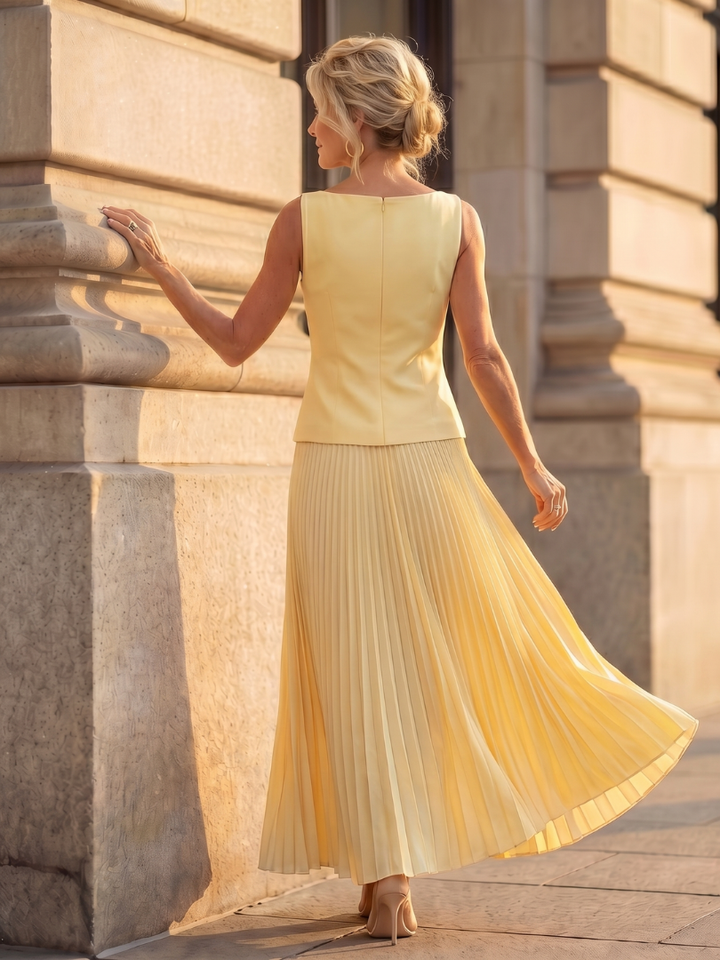 Elegant women's skirt set with a fitted bodice and a full pleated maxi skirt, ideal for events.